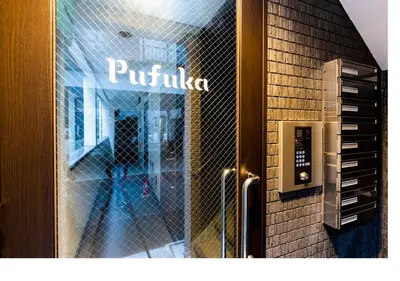 a glass door of a building with a sign on it at \u3077\u3075\u304bTK\u6771\u5411\u5cf62F - 1min to Higashi Mukojima Sta 2F Cozy Stay Near Skytree Asakusa in Tokyo