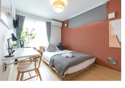 a bedroom with a bed and a desk and a desk at \u3077\u3075\u304bTK\u6771\u5411\u5cf62F - 1min to Higashi Mukojima Sta 2F Cozy Stay Near Skytree Asakusa in Tokyo