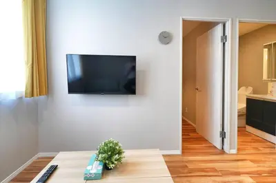 a living room with a flat screen tv on a wall at ZJ202 Hanama202 The Skytree Residence A Newly Home by Tokyo Iconic Landmarks in Tokyo