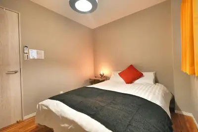 a bedroom with a bed with a red pillow on it at ZJ202 Hanama202 The Skytree Residence A Newly Home by Tokyo Iconic Landmarks in Tokyo