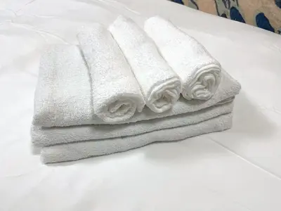 a pile of towels sitting on top of a table at japanese art kiyo-e house traditional towns self check in in Tokyo