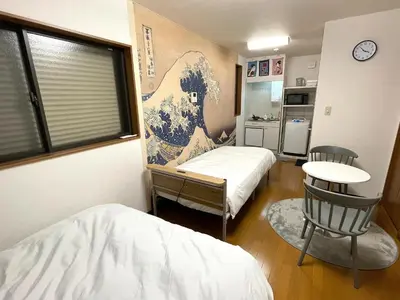 a room with two beds and a table and a window at japanese art kiyo-e house traditional towns self check in in Tokyo