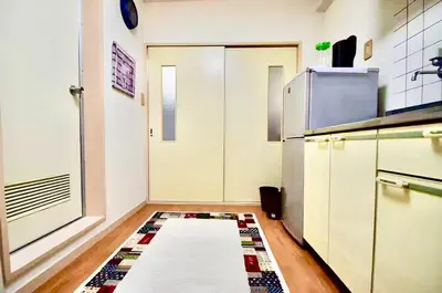 a kitchen with a door and a rug on the floor at #5 -\u30a8\u30af\u30bb\u30eb\u6a4b\u7acb103- Entire Unit in Tokyo