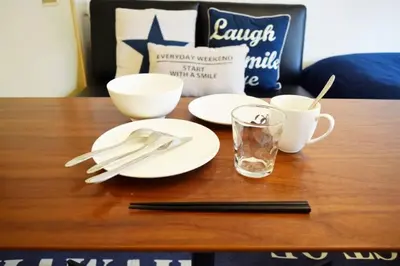 a table with white plates and cups and utensils at #6 -\u30a8\u30af\u30bb\u30eb\u6a4b\u7acb203- Entire Unit in Tokyo