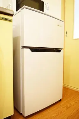 a white refrigerator freezer sitting in a kitchen at #6 -\u30a8\u30af\u30bb\u30eb\u6a4b\u7acb203- Entire Unit in Tokyo