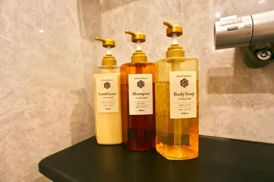 three bottles of liquid sitting on a shelf at Metro 4 min to Shinjuku St Luxury Home in Shinjuku City in Tokyo