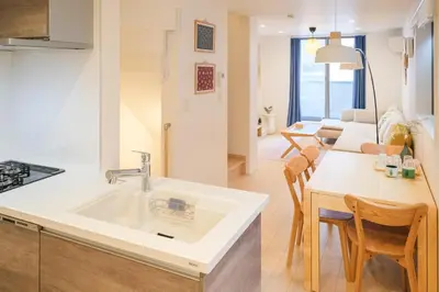 a kitchen and living room with a sink and a table at Mi-Villa SOMO in Tokyo