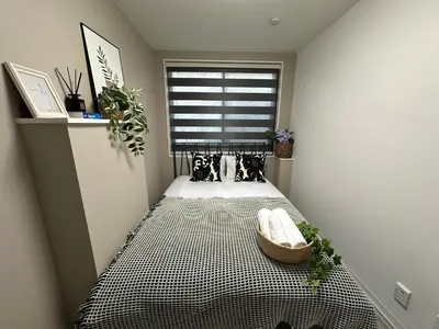 a small bedroom with a bed and a window at COMMA HOUSE Shinjuku 11 in Tokyo
