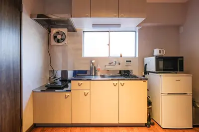 a small kitchen with a sink and a refrigerator at Mi-APT TAKINO in Tokyo