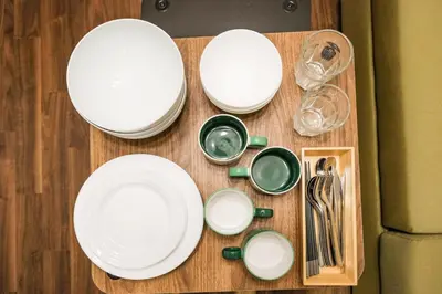 a table with white plates and utensils on it at Mi-APT TAKINO in Tokyo