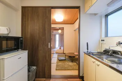 a kitchen with a door leading to a hallway at Mi-APT TAKINO in Tokyo