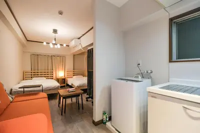 a hotel room with a bed and a living room at Mi-APT TAKINO in Tokyo