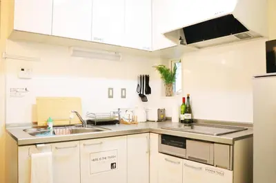 a kitchen with white cabinets and a sink at OHANA TOKYO HOUSE - Vacation STAY 67721v in Tokyo