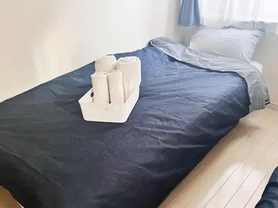 a bed with a box of towels on it at OHANA TOKYO HOUSE - Vacation STAY 67721v in Tokyo