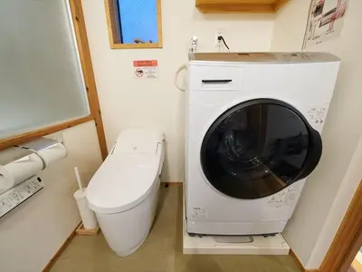 a washing machine sitting next to a toilet in a bathroom at Accommodation Kisakata - Vacation STAY 63868v in Tokyo