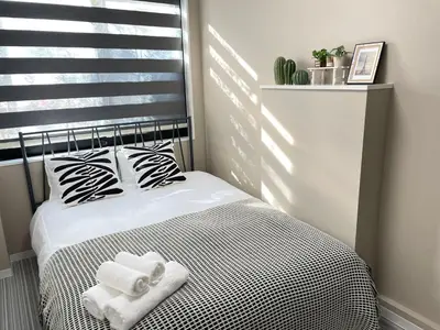 a bedroom with a bed with two towels on it at COMMA HOUSE Shinjuku 14 in Tokyo