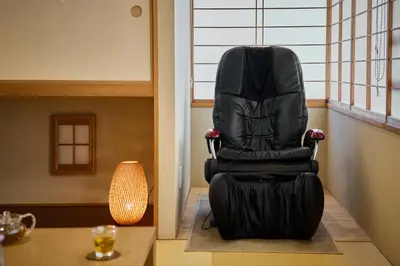 a black chair sitting in a room next to a table at KEYAKIAN Tokyo Nihonbashi in Tokyo