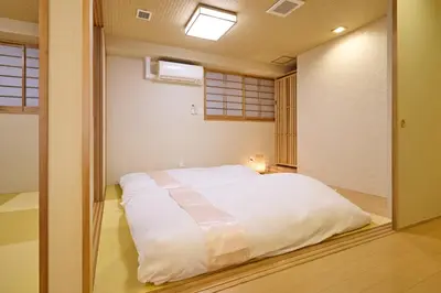 a bedroom with a large white bed in a room at KEYAKIAN Tokyo Nihonbashi in Tokyo