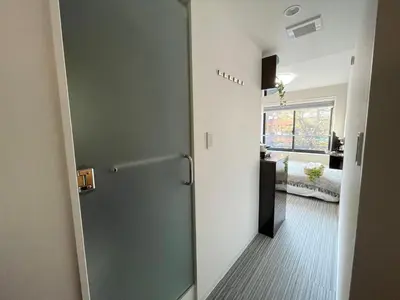 a hallway with a door leading to a living room at COMMA HOUSE Shinjuku301 in Tokyo