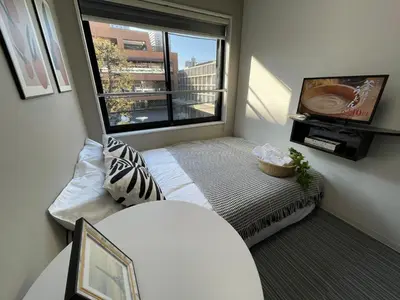 a small room with a bed and a window at COMMA HOUSE Shinjuku301 in Tokyo