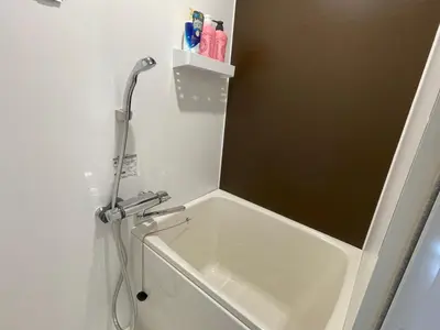 a bathroom with a shower and a bath tub at COMMA HOUSE Shinjuku302 in Tokyo