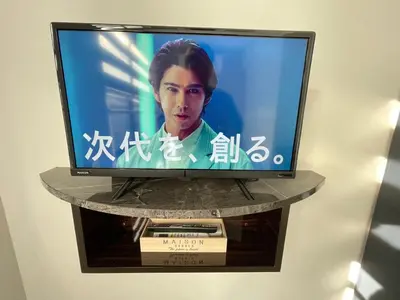 a flat screen tv on a stand in a room at COMMA HOUSE Shinjuku302 in Tokyo