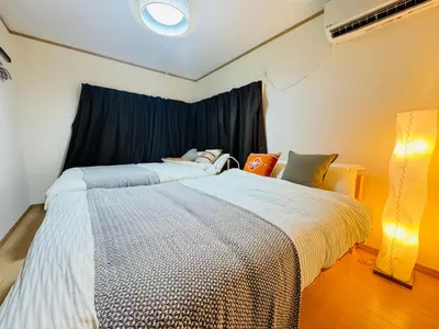 a bedroom with two beds and a window at shibuya sakaraku-SY0027 in Tokyo
