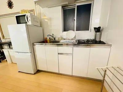 a kitchen with white cabinets and a white refrigerator at shibuya sakaraku-SY0027 in Tokyo