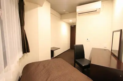 a room with a bed and a desk and a chair at HOTEL LiVEMAX Nihonbashi Hakozaki in Tokyo