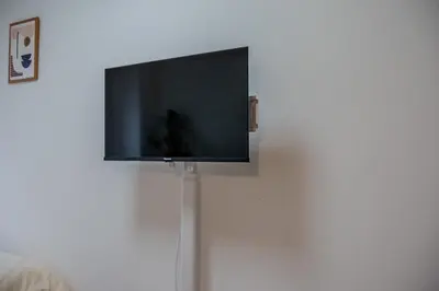 a flat screen tv hanging on a wall at #8 -\u30a2\u30a4\u30e0\u30bf\u30a6\u30f3\u5357\u845b\u897f- Entire Unit in Tokyo