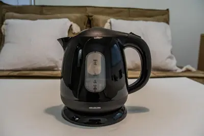 a black tea kettle sitting on a table at #8 -\u30a2\u30a4\u30e0\u30bf\u30a6\u30f3\u5357\u845b\u897f- Entire Unit in Tokyo
