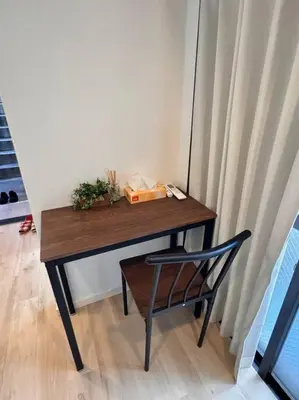 a wooden table with a chair next to a curtain at \u68ee\u4e0b\u99c52\u5206 sky tree view 501 in Tokyo