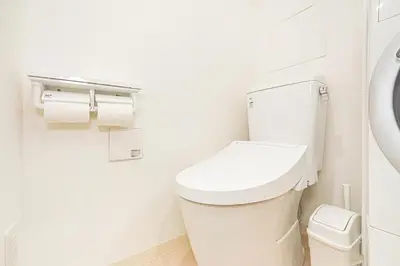 a bathroom with a toilet and two rolls of toilet paper at New-built APT at Asakusa-Skytree area with Tranquil block in Tokyo
