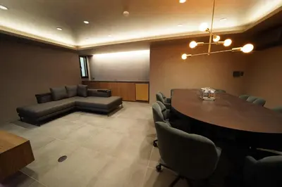 a conference room with a table and chairs and a couch at Musashi Condo Takadanobaba in Tokyo