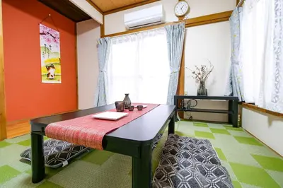 a dining room with a table and a window at Vivi Villa in Tokyo
