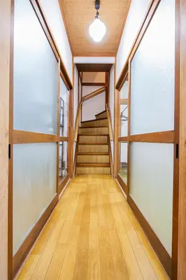 a hallway with glass doors and stairs in a building at Vivi Villa in Tokyo