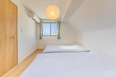 a small bedroom with a bed and a window at Four Trees Stay Yotsugi Skytree View in Tokyo
