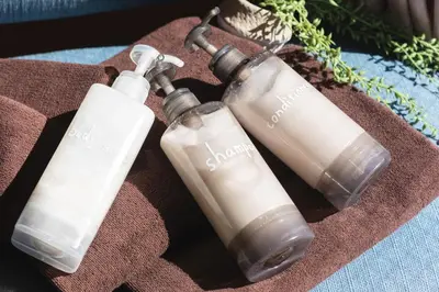 three white bottles sitting on top of a towel at Four Trees Stay Yotsugi Skytree View in Tokyo