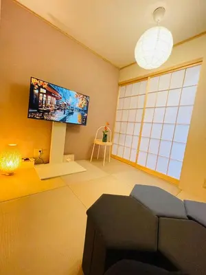 a living room with a couch and a flat screen tv at Fang-Shibadaimon-house-MT0300 in Tokyo