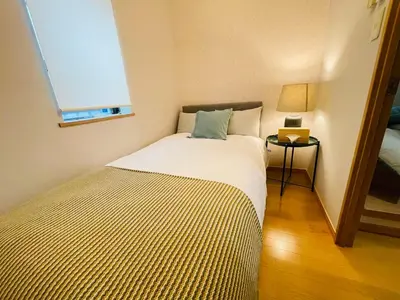 a small bedroom with a bed and a window at Fang-Shibadaimon-house-MT0300 in Tokyo