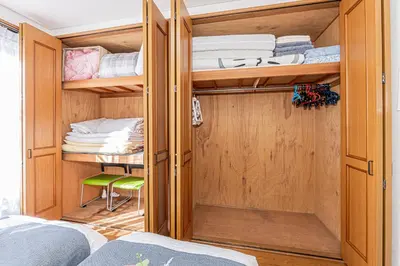 a bedroom with wooden cabinets and bunk beds at Happy House NIshi-Koiwa Keisei Koiwa Station 5min in Tokyo