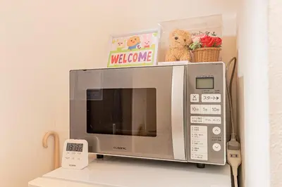 a microwave oven sitting on top of a shelf at Happy House NIshi-Koiwa Keisei Koiwa Station 5min in Tokyo