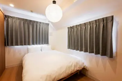 a bedroom with a white bed and a large window at Casa Stella Tokyo #3 Higashi Shinjuku in Tokyo