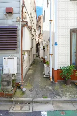 an alleyway between two buildings in a city at Hotel SHIBA INU in Tokyo