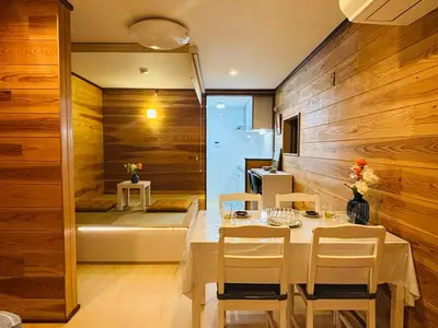 a dining room with wooden walls and a table and chairs at Lapis House 101 - 1F in Tokyo