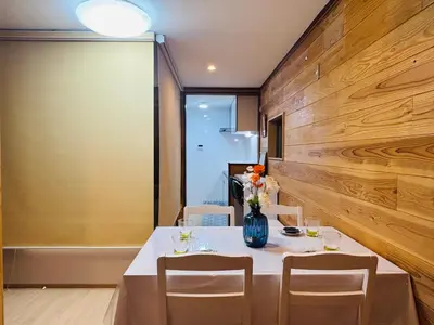 a table with chairs and a vase of flowers on it at Lapis House 101 - 1F in Tokyo