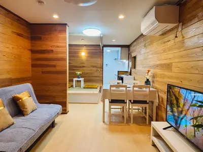 a living room with a couch and a dining room at Lapis House 101 - 1F in Tokyo