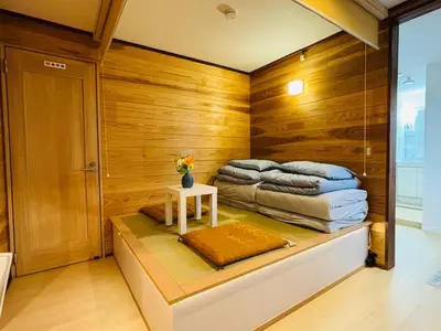 a room with a bed and a table with towels at Lapis House 101 - 1F in Tokyo