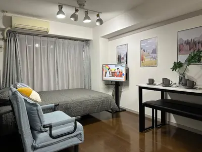 a bedroom with a bed and a chair and a television at jr\u5c71\u624b\u7ebf \u99d2\u8fbc\u8f66\u7ad93\u5206\u949f \u76f4\u8fbe\u65b0\u5bbf\u6d89\u8c37\u6c60\u888b\u4e0a\u91ce\u79cb\u53f6\u539f Max7 in Tokyo
