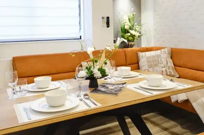 a dining room table with plates and glasses on it at \u4f59\u82b1\u91ccSakura Tokyo\u68ee\u4e0b in Tokyo